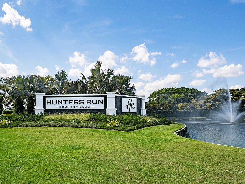 Entrance sign and lake at a Boynton Beach golf community